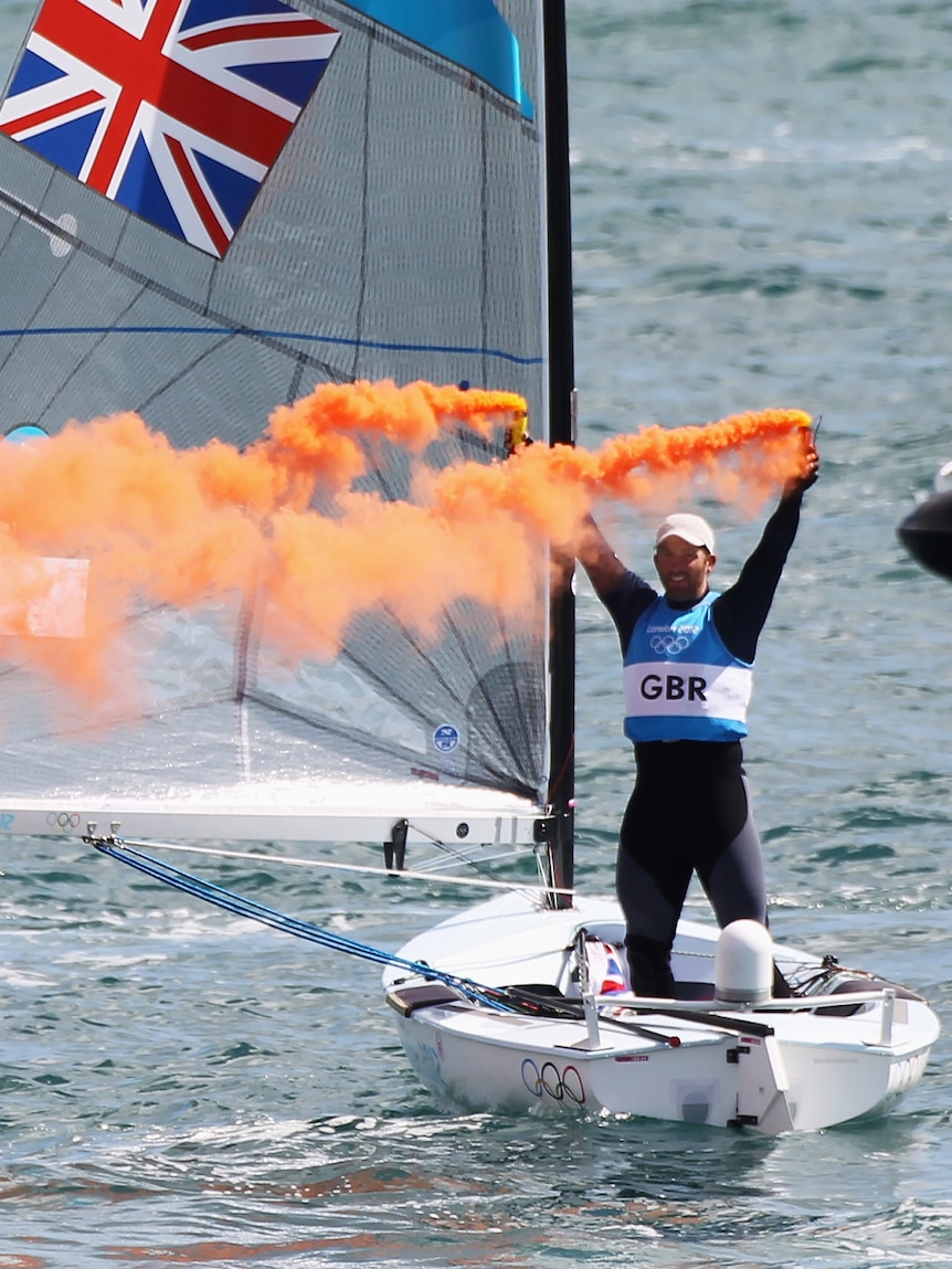 Briton Ben Ainslie celebrates gold after winning in the men's star sailing medal race