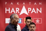 Mahathir reacts to the reporters as he arrives for a press conference to announce his cabinet members in 2018.