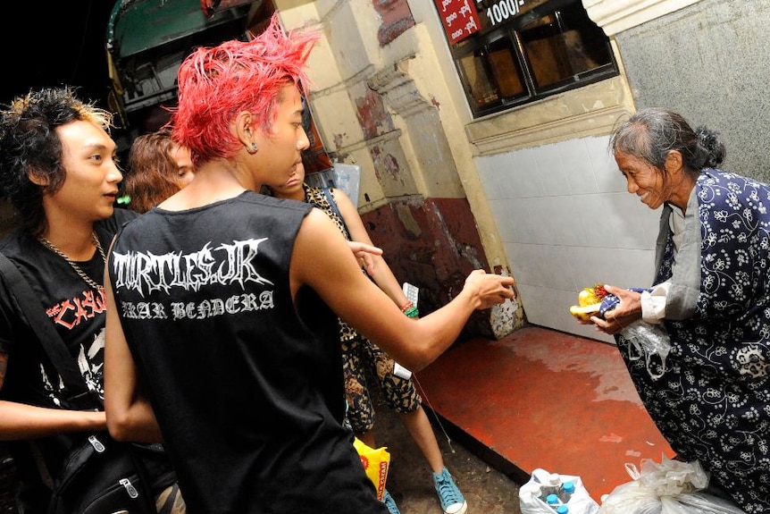 Kyaw Kyaw and his punk friends go through Yangon to hand out food donations to homeless people