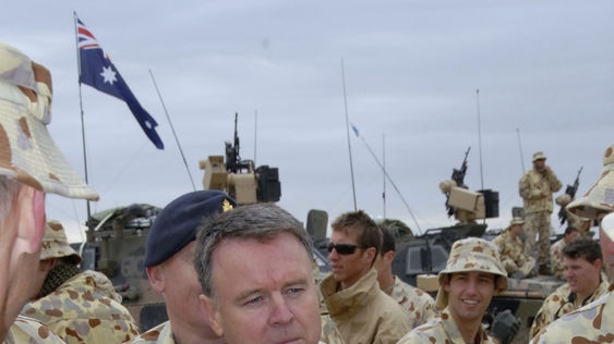 Defence Minister Joel Fitzgibbon surrounded by Australian troops in Iraq