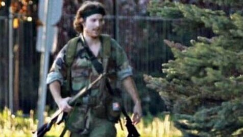 Suspect in Canadian police shootings Justin Bourque walking on a Moncton street on June 4, 2014.