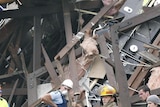 Rescuers stop to listen for sounds from survivors in a collapsed building
