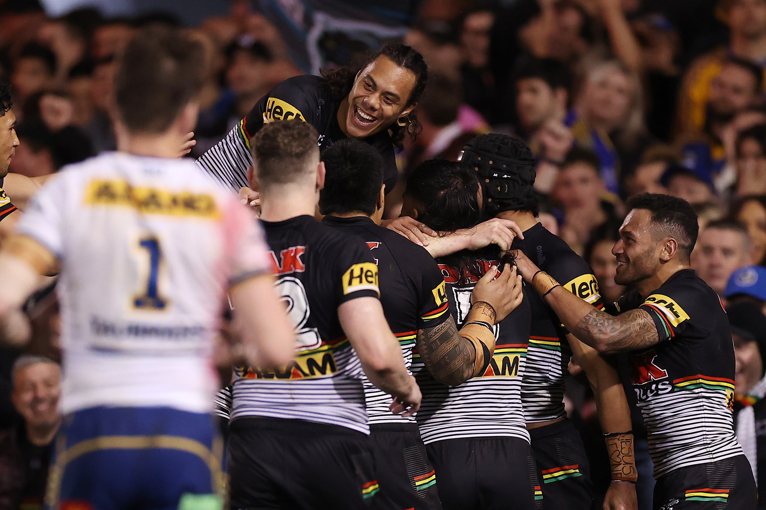 A rugby league team celebrate a try