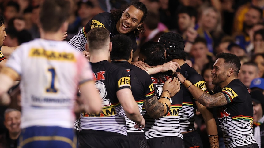 A rugby league team celebrate a try