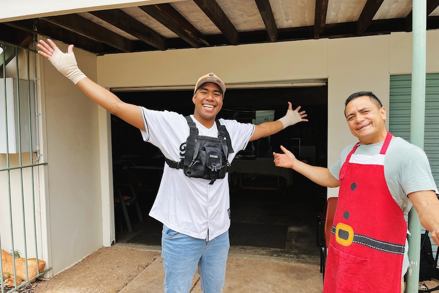 two men smile at camera