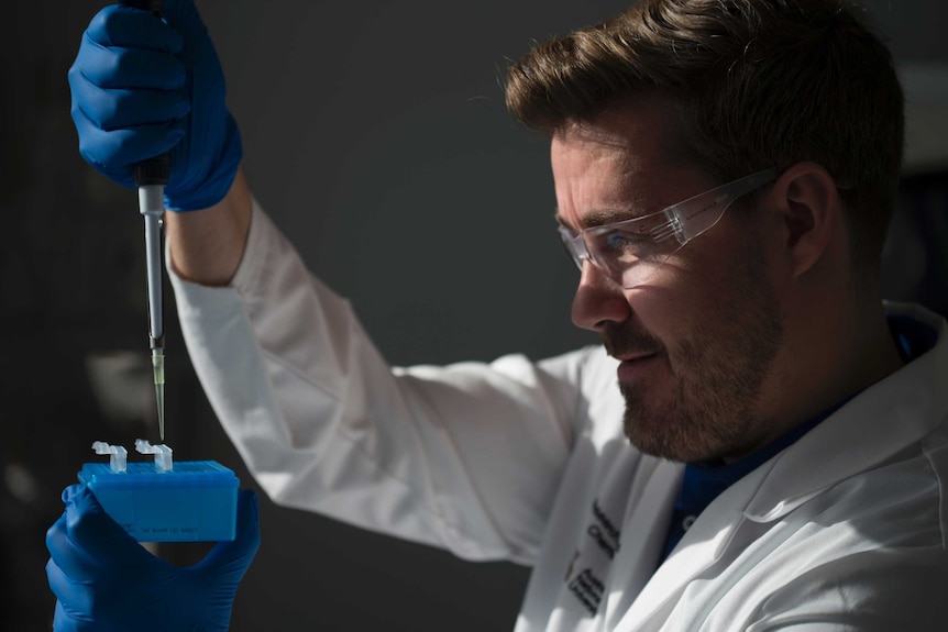 A scientist Dr testing his "do-it-yourself" kit to detect diseases like malaria.