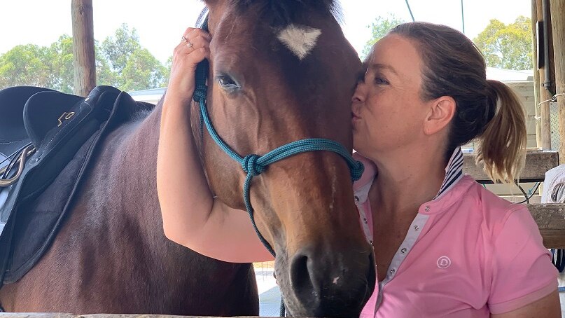 Natasha Johnson kisses her horse.