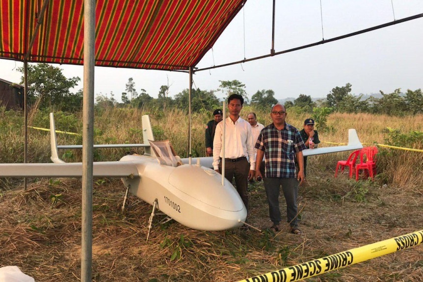 The scene of the drone crash site and officers surrounding it.