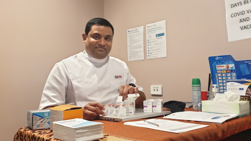 Dorrigo Pharmacist Sri Popuri sitting in front of vaccines 