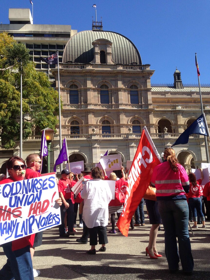 Members of the Qld Nurses Union protest outside State Parliament in Brisbane today.
