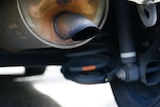 A close-up of a tarnished car exhaust pipe