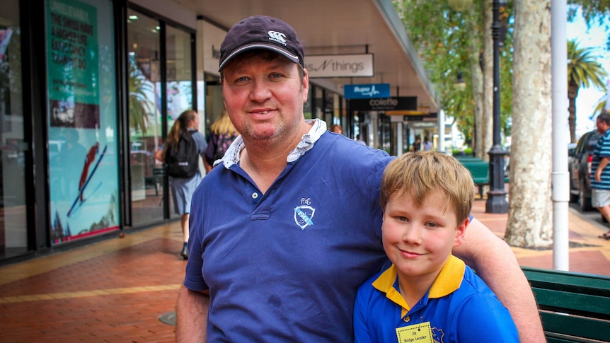 Father and son sitting in the street in Tamworth