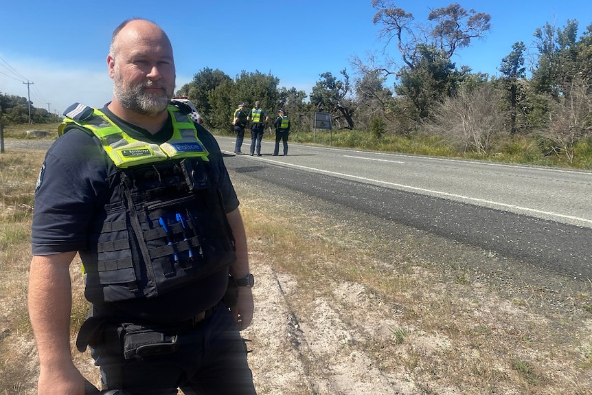 A police officer stands near a roadblock in Gippsland.