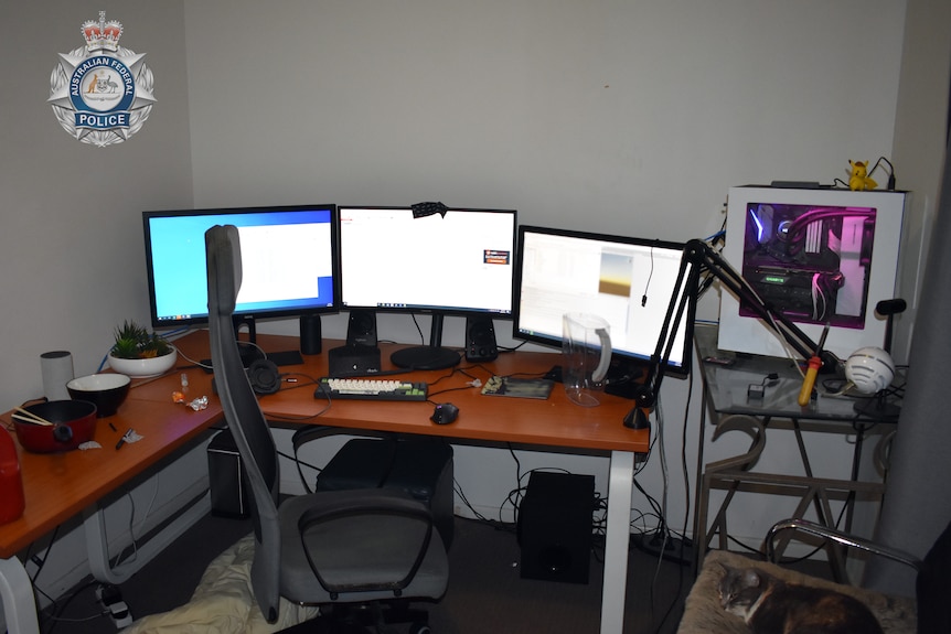 Computer monitors on a desk. 