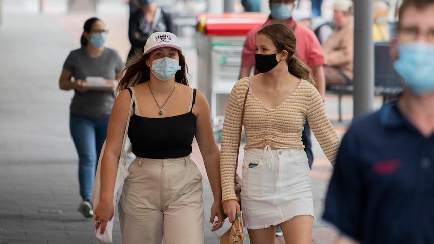 People on the street wearing a mask.