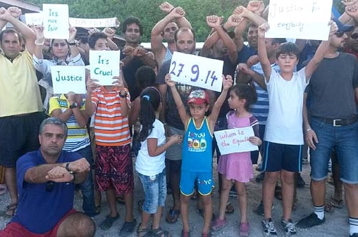 Adults and children protest at a Nauru family residential compound