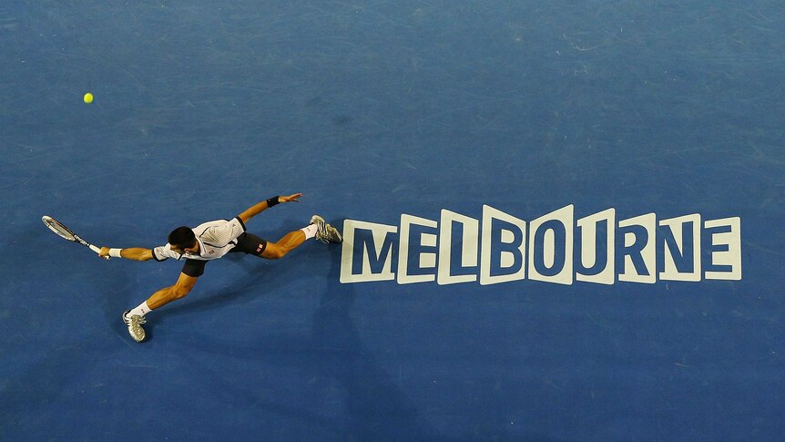 Novak Djokovic slides to play a backhand in his Australian Open quarter-final.