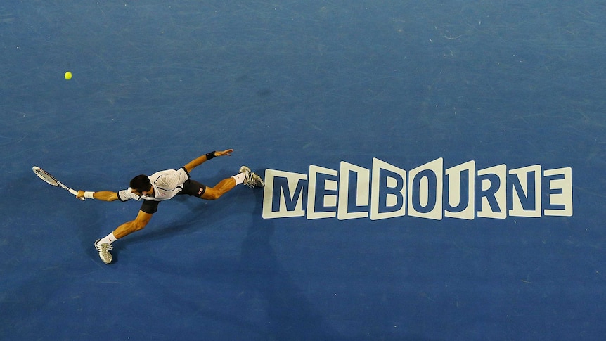 Novak Djokovic slides to play a backhand in his Australian Open quarter-final.