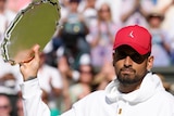 Nick Kyrgios holds aloft the runner-up Wimbledon trophy after losing the final to Novak Djokovic.
