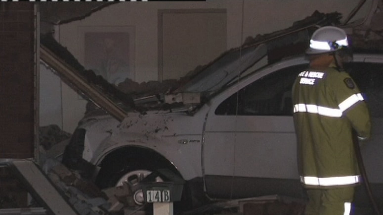 Car ploughs into home