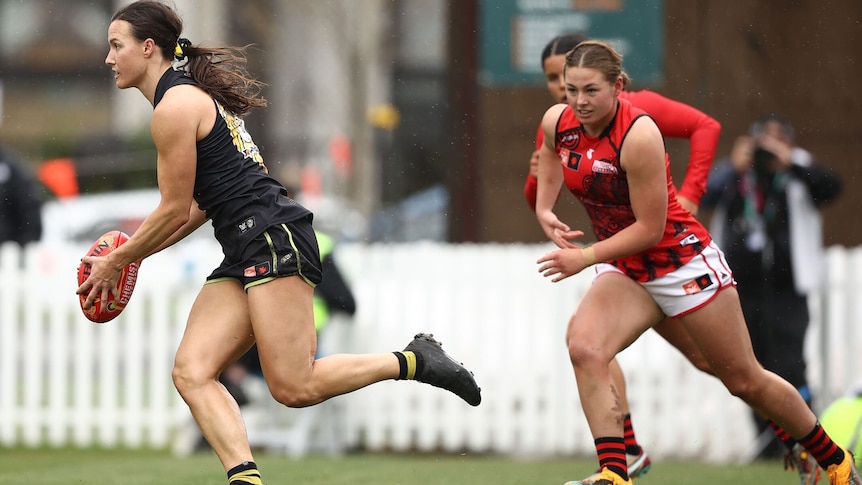 two AFLW players during a match