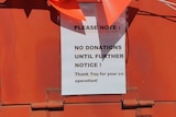 A sign on the donations bin telling people not to donate.