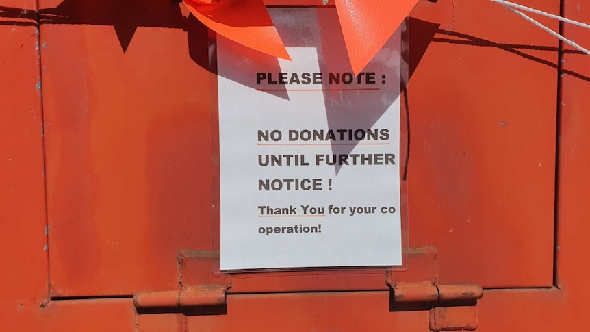 A sign on the donations bin telling people not to donate.