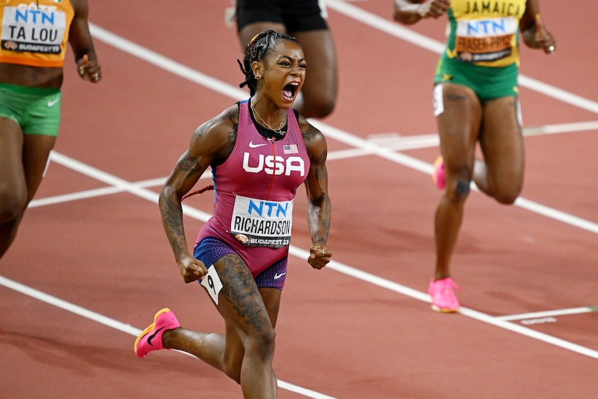 Sha'Carri Richardson yells in delight as she crosses the line first