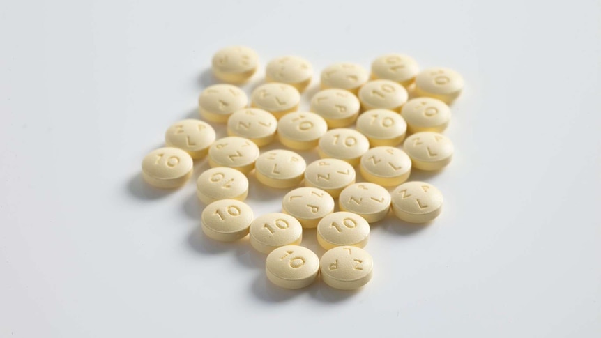 A collection of round pharmaceutical pills on a white surface