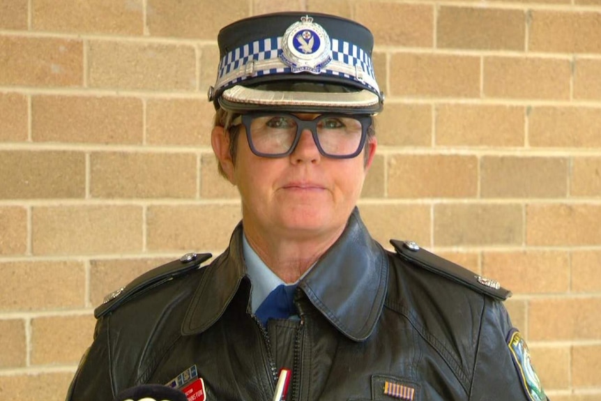 Woman wearing a police cap looking