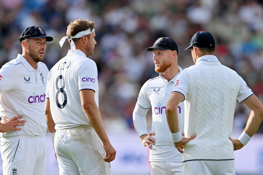Ollie Robinson, Stuart Broad, Ben Stokes and Jimmy Anderson talk during an Ashes Test.
