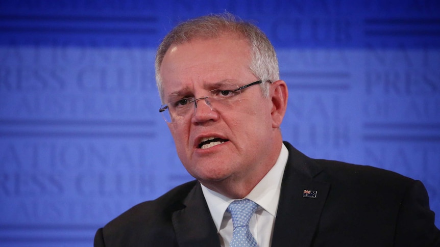 Scott Morrison speaks on a stage.