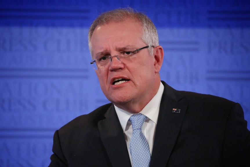 Scott Morrison speaks on a stage.