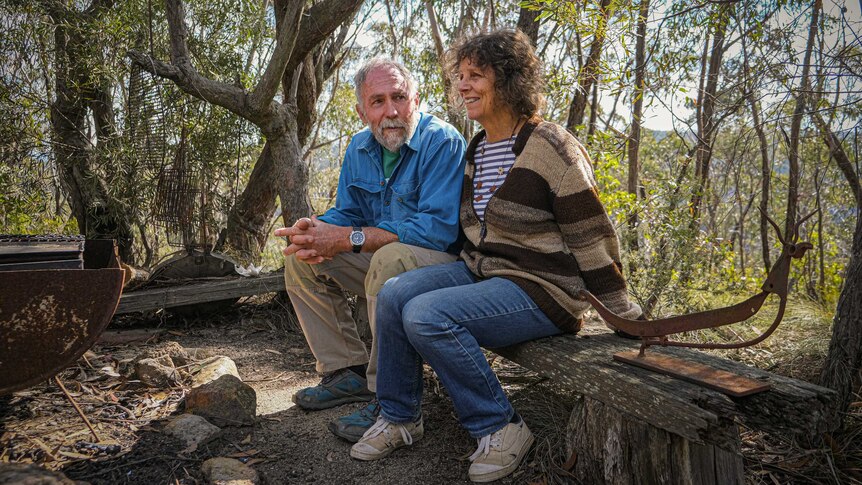 Rolley Clarke and Robin sitting on a wooden seat, just metres from their Mt Victoria home