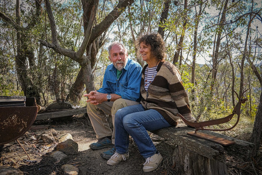 Rolley Clarke and Robin sitting on a wooden seat, just metres from their Mt Victoria home