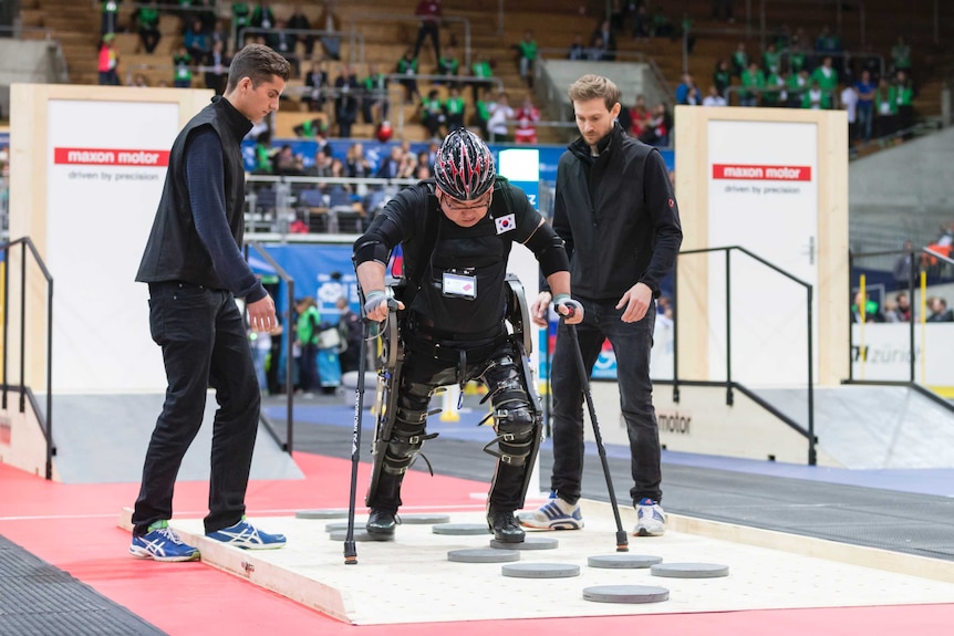 SG-Mechatronics competitor walking across stepping stones in his exoskeleton during Cybathlon