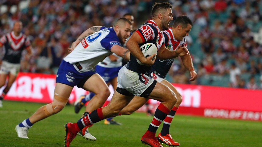 James Tedesco and Cooper Cronk run chased by Bulldogs players.