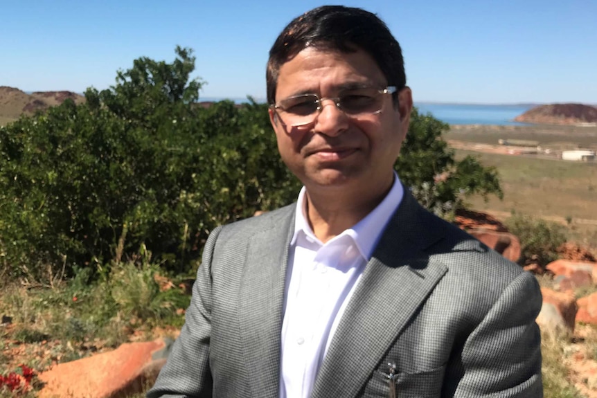 Medium shot of Vikas Rambal overlooking the industrial area on the Burrup