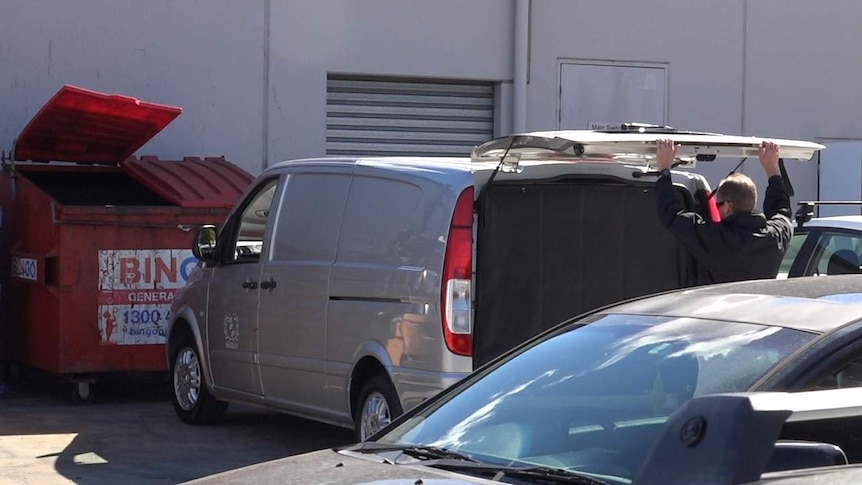 A body being identified in a NSW shopping centre carpark.