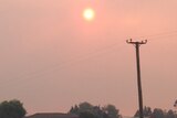 The sun shines through bushfire smoke