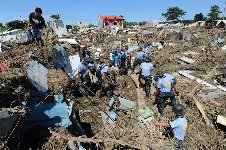 Police help in the wake of Typhoon Washi on the southern island of Mindanao.