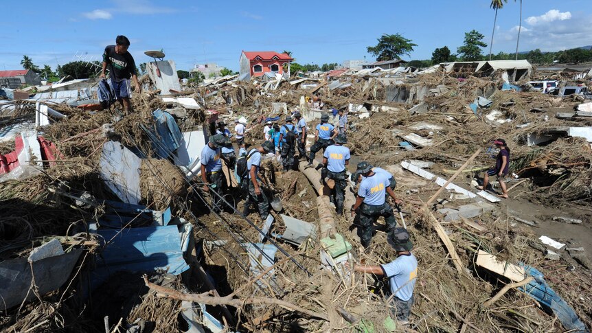 Police help in the wake of Typhoon Washi on the southern island of Mindanao.