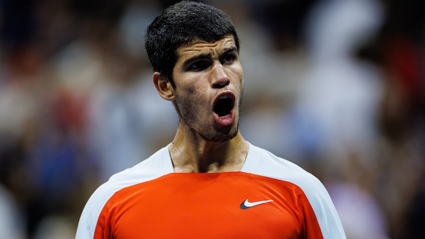 A male Spanish tennis player celebrates winning a match at the US Open.