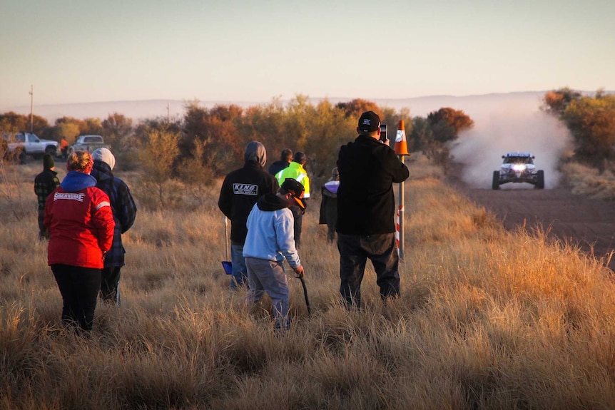 Spectators follow Finke Desert Race.