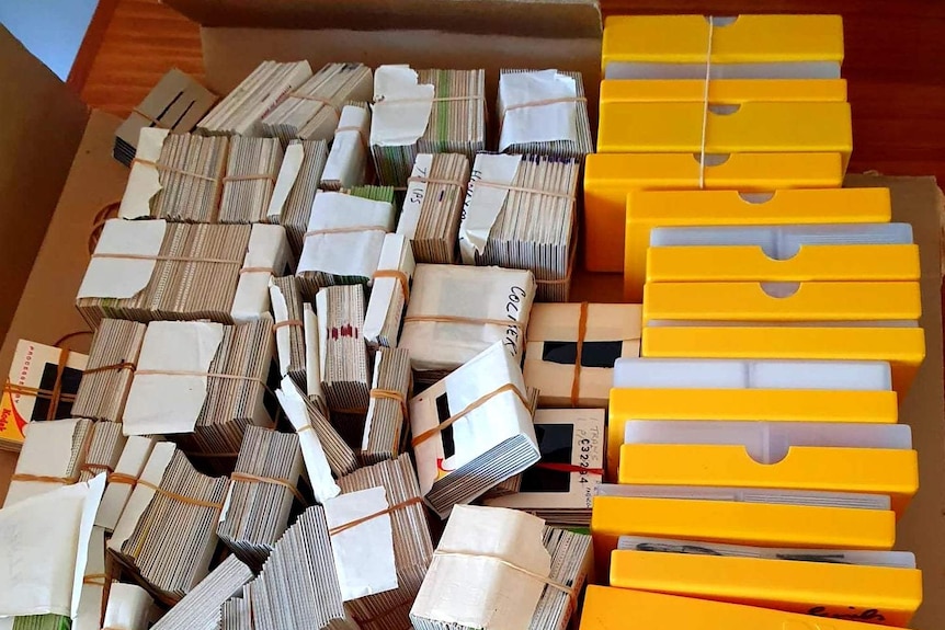 Yellow and white boxes containing photo slides to be digitised.