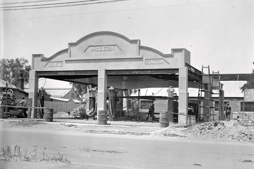 Old photograph of the facade of a petrol station.