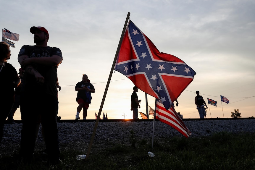 Supporters of Donald Trump at the Ohio rally hold a Confederate flag