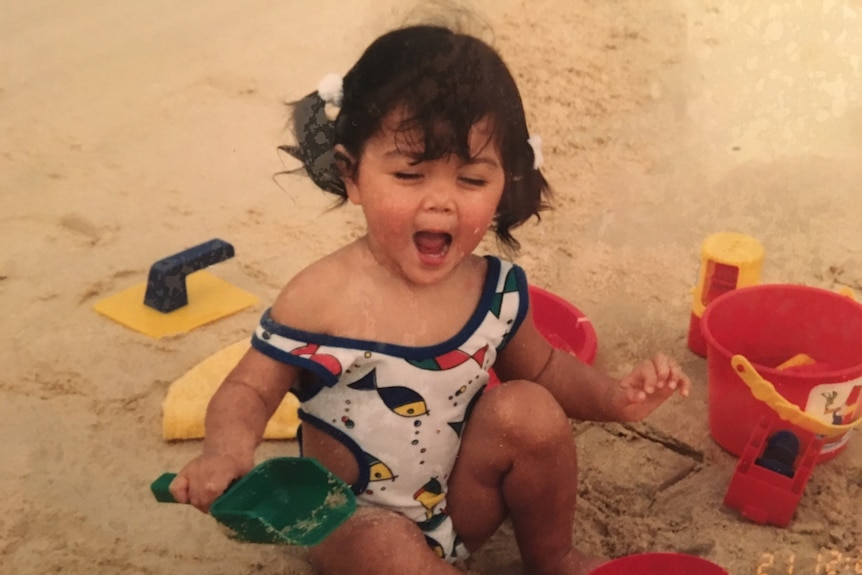 Melbourne chef Rosheen Kaul playing in the sand at the beach while young. She immigrated to Australia as a child.