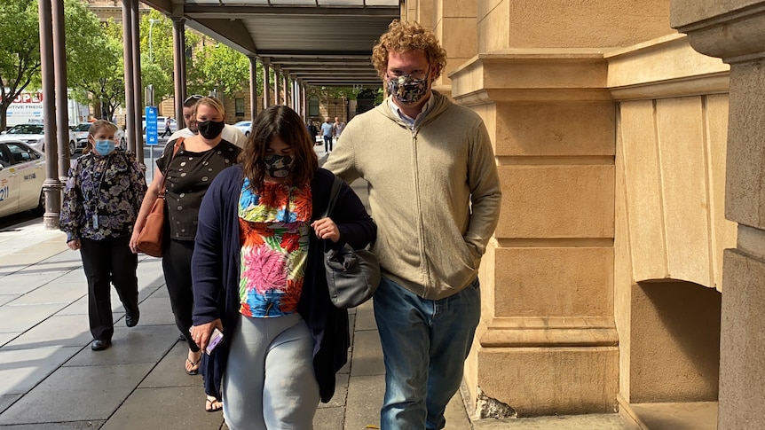 A group of people wearing face masks on a city street