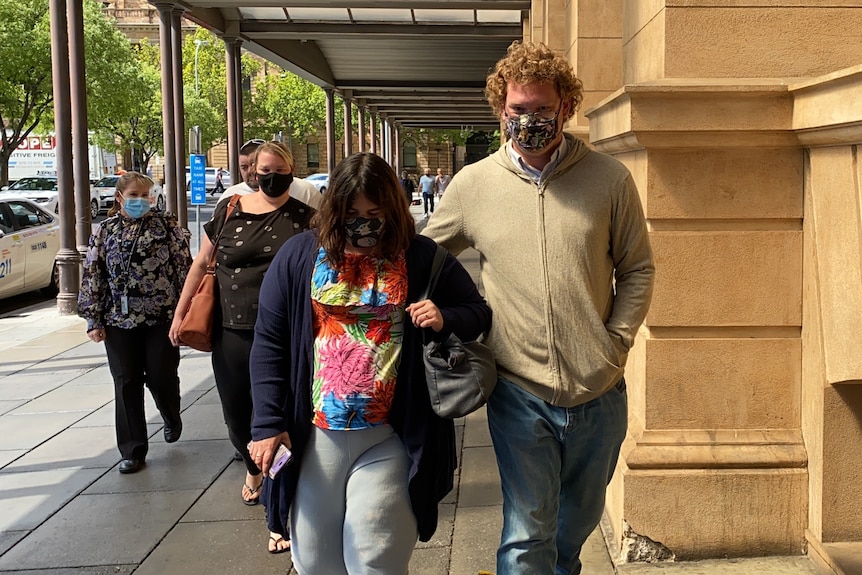 A group of people wearing face masks on a city street